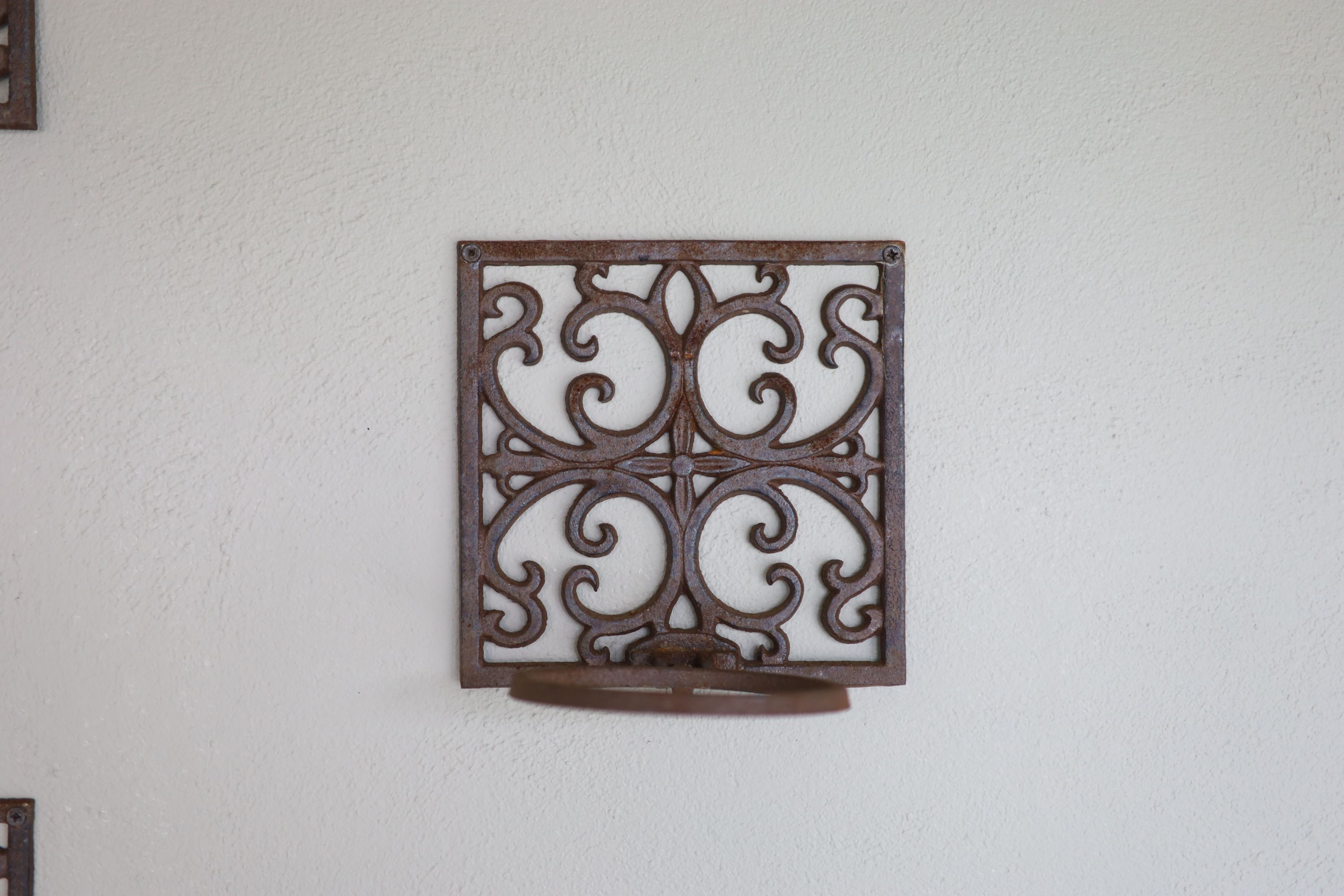 A set of eighteen wrought iron wall mounted folding plant pot holders, width 19.5cm